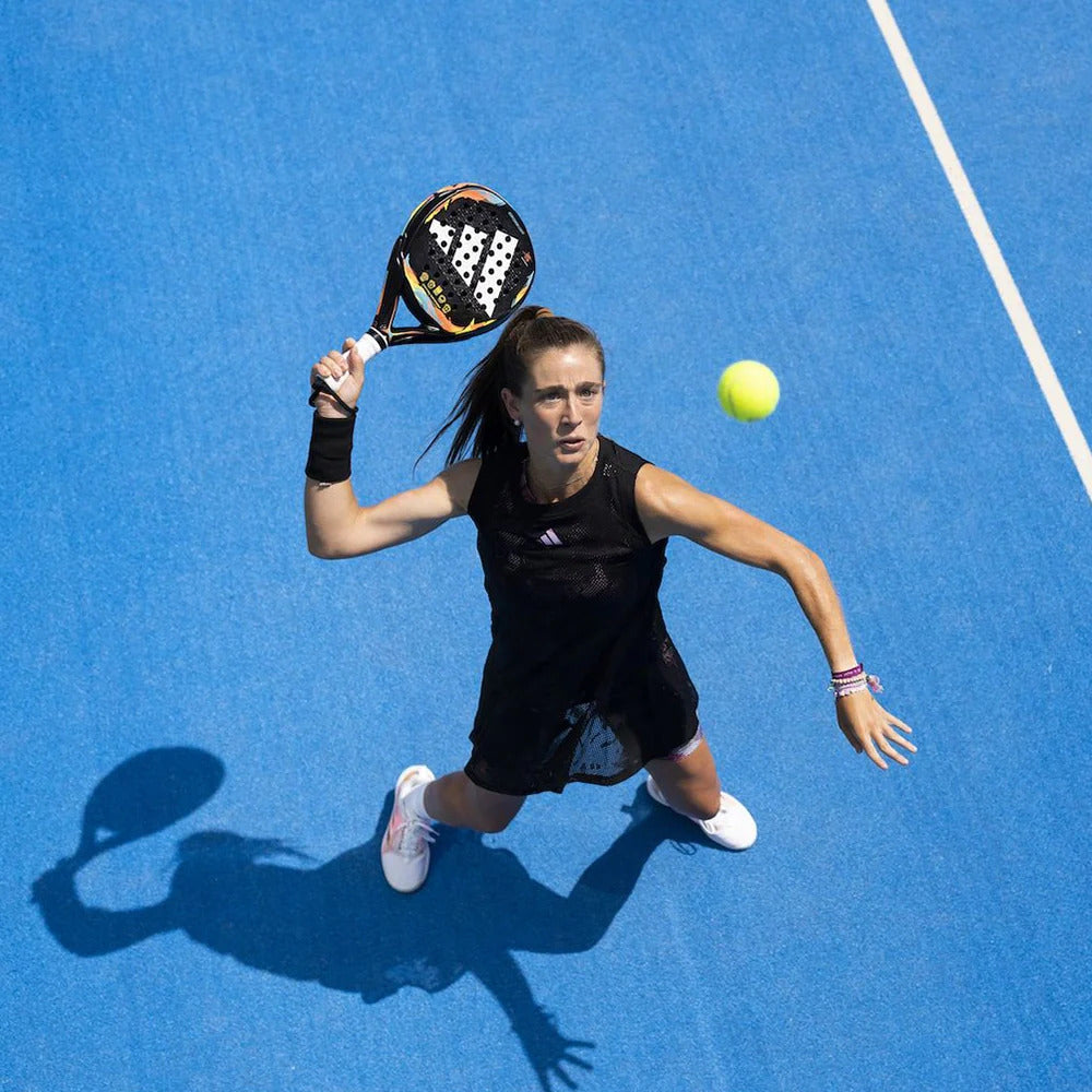 Padel player holding round padel racquet on the court