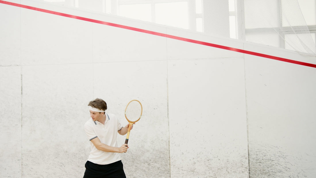 Photo by Artem Podrez: https://www.pexels.com/photo/man-wearing-a-white-polo-shirt-holding-a-squash-racket-7648075/